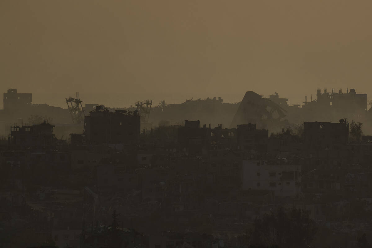 Destroyed buildings in the Gaza Strip are seen during the sunset from southern Israel, Thursday ...