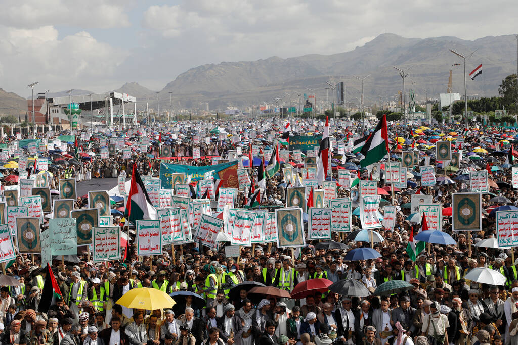 Houthi supporters attend a rally against the U.S.-led strikes against Yemen and in support of P ...