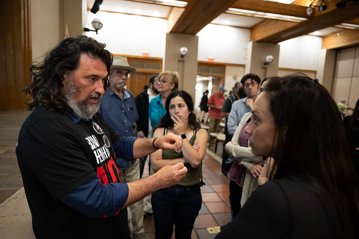 Ilya Tarshansky speaks Thursday with Carmit Novitzky, right, and Dror Kohler, center, about his ...