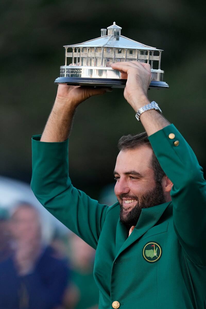 Scottie Scheffler holds the trophy after winning the Masters golf tournament at Augusta Nationa ...