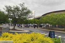 Guests line up outside Gas South Arena in Gwinnett County for Emory University's 2024 undergrad ...