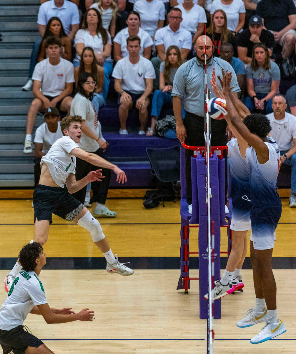 Palo Verde's Cole Manning (8) spikes the ball against Coronado's Jayden Bell (12) and Dexter Br ...