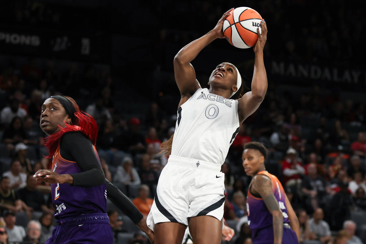 Las Vegas Aces guard Jackie Young (0) shoots against Phoenix Mercury guard Kahleah Copper (2) d ...