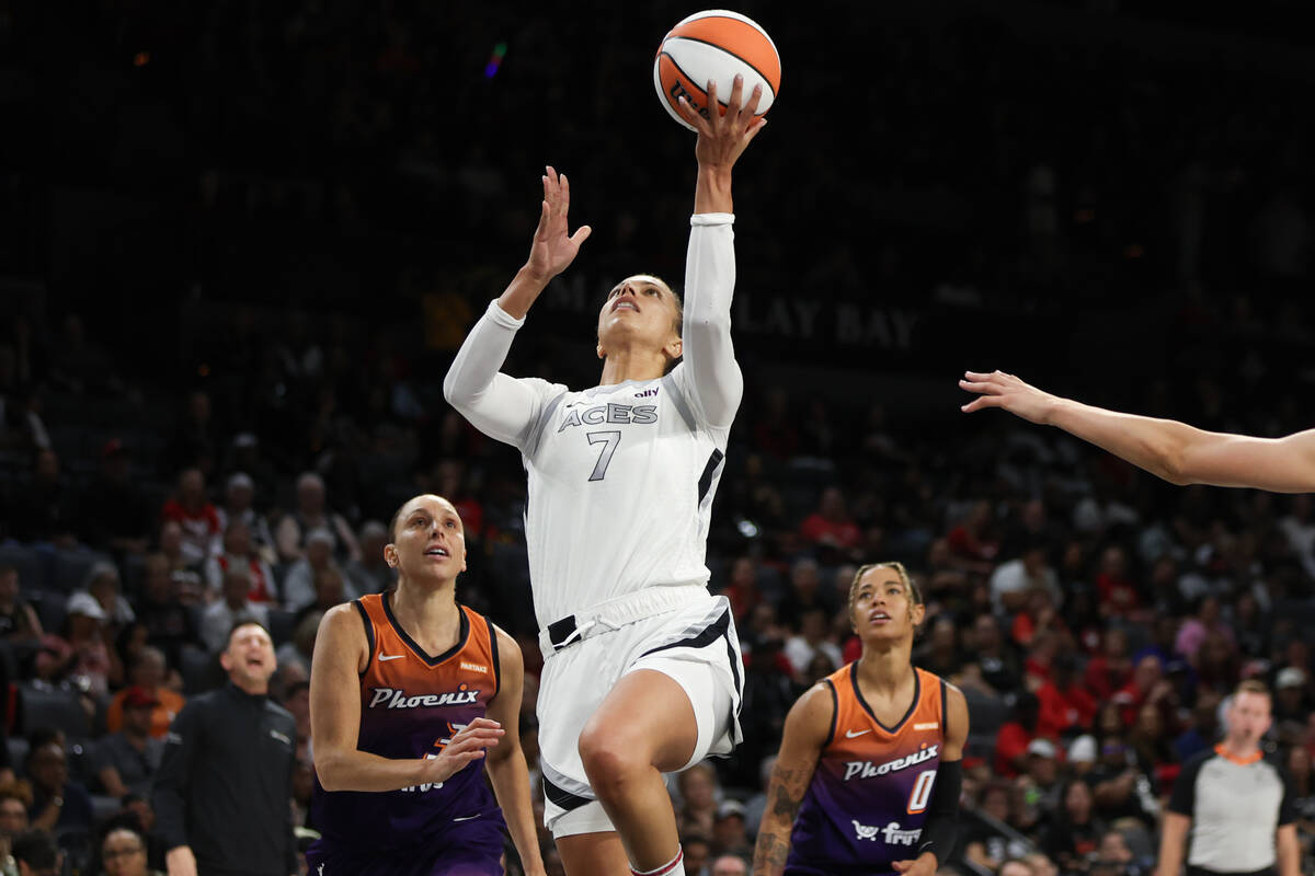 Las Vegas Aces forward Alysha Clark (7) shoots while Phoenix Mercury guard Diana Taurasi (3) an ...