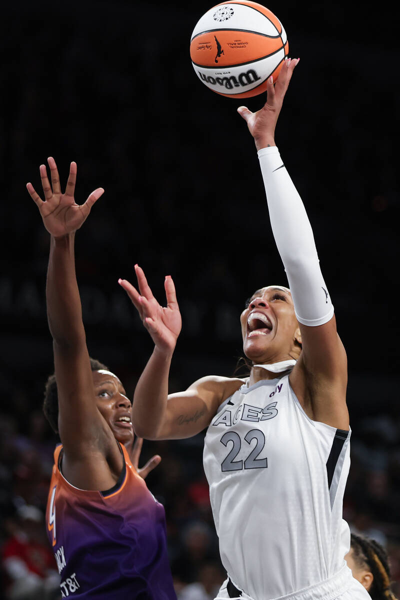 Las Vegas Aces center A'ja Wilson (22) shoots against Phoenix Mercury forward Natasha Mack (4) ...