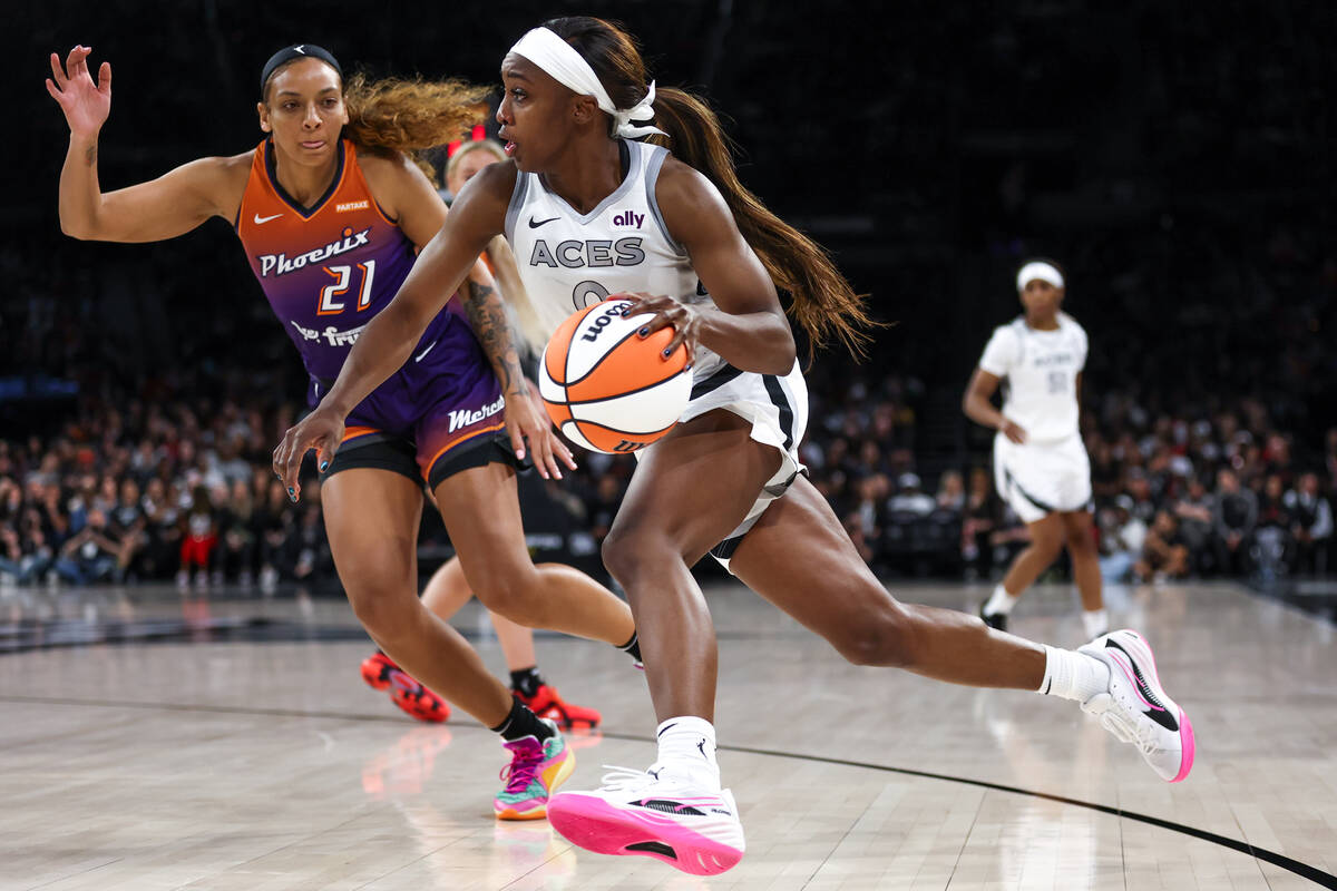 Las Vegas Aces guard Jackie Young (0) drives toward the hoop against Phoenix Mercury forward Mi ...