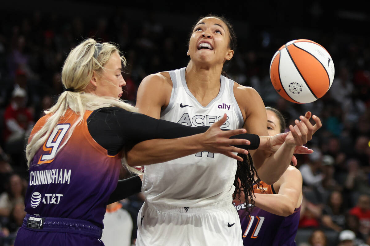 Las Vegas Aces center Kiah Stokes (41) is fouled by Phoenix Mercury guard Sophie Cunningham (9) ...