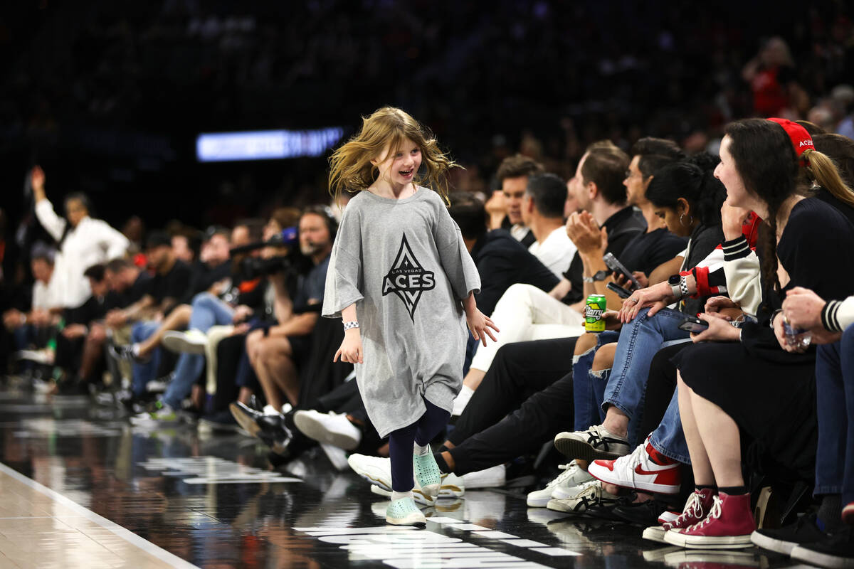 A young fan runs on the sideline during the second half of a WNBA basketball game between the L ...