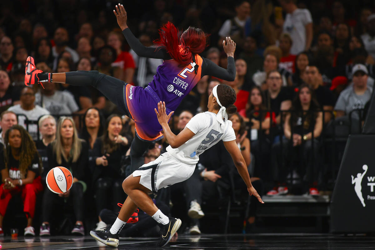 Phoenix Mercury guard Kahleah Copper (2) and Las Vegas Aces guard Sydney Colson (51) fall to th ...