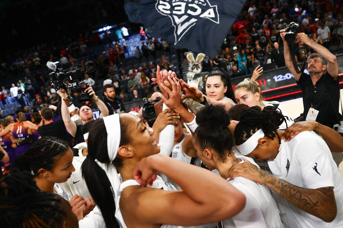 The Las Vegas Aces gather after winning a WNBA basketball game against the Phoenix Mercury at M ...