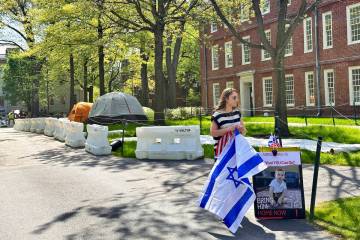 Rotem Spiegler, an alumni of Harvard University, stands near an encampment set up at the univer ...