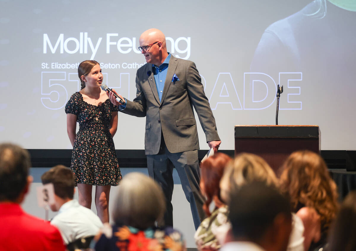 Chet Buchanan, professional radio and television host, asks a question of fifth grade winner Mo ...