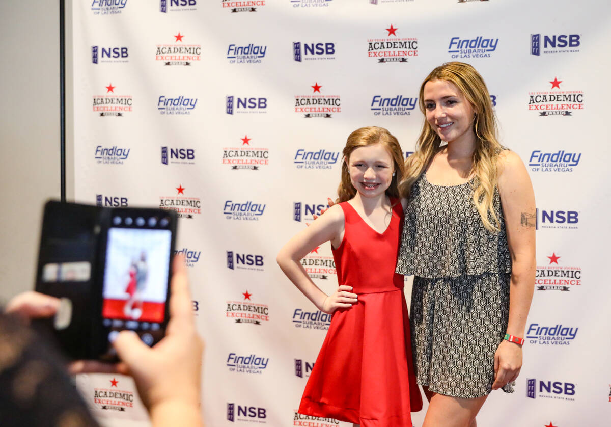 Venna Blasco, sixth grade winner, takes a photo with her cousin Ryleigh Yanke at the Las Vegas ...