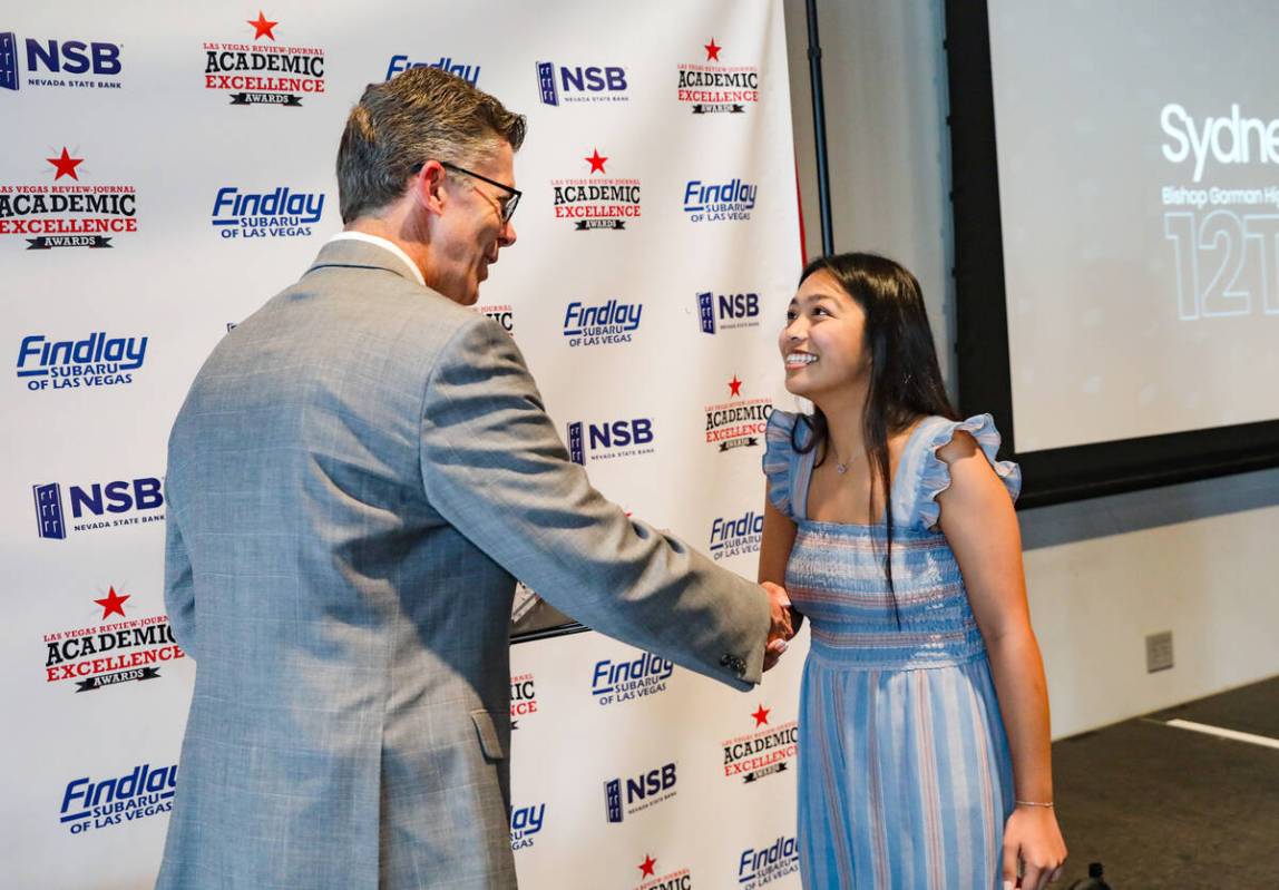 Review-Journal’s Executive Editor Glenn Cook greets twelfth grade winner Sydney Obispo-Dizon ...