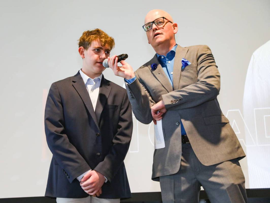 Chet Buchanan, professional radio and television host, asks a question of ninth grade winner Et ...