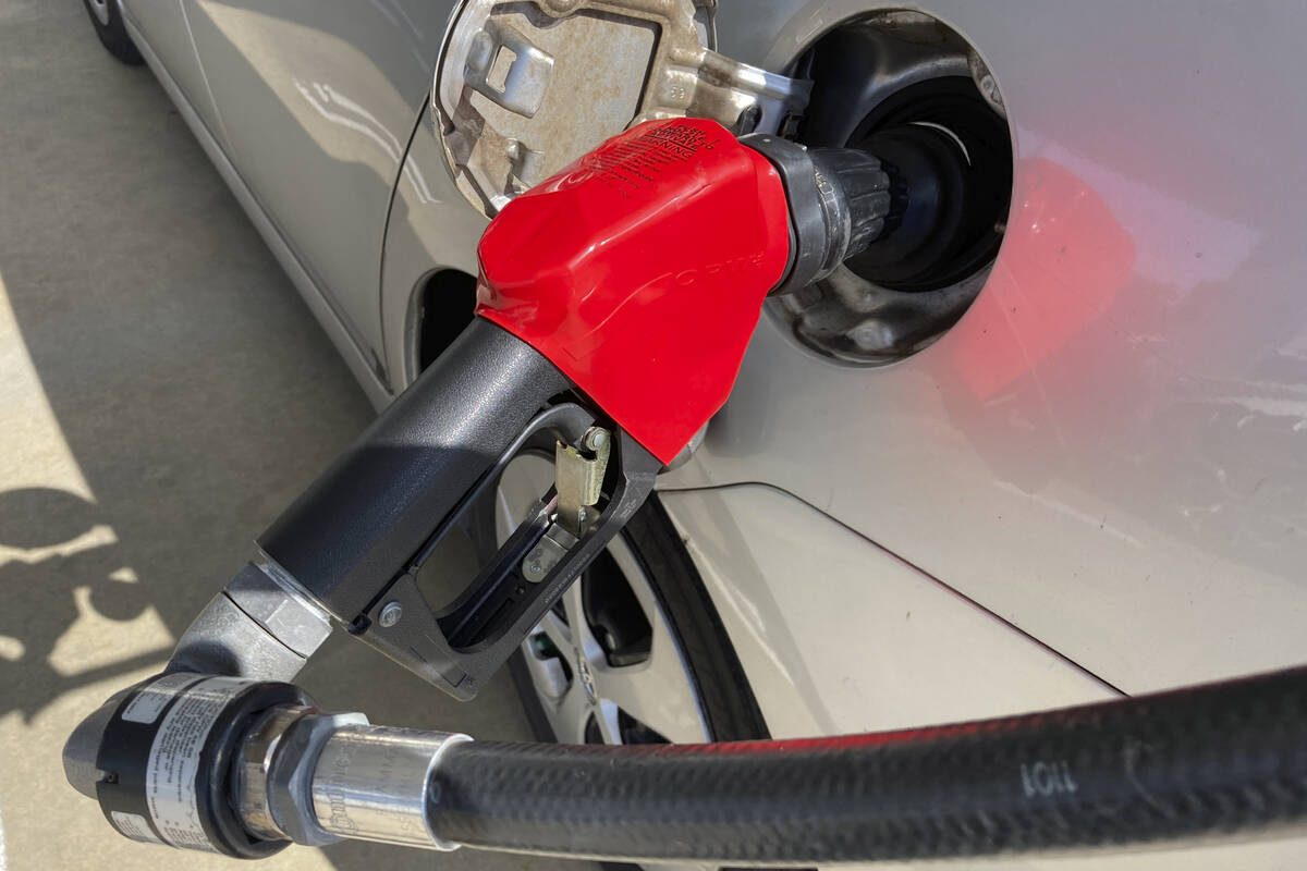A car is shown at a gas pump, Friday, Jan. 21, 2022, at a gas station. (AP Photo/Wilfredo Lee)