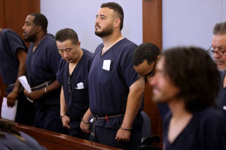 Eddi Moreno, center, who is accused of shooting and killing his next-door neighbor after the ma ...
