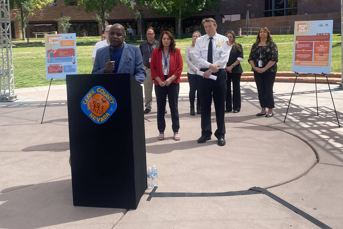 Dr. Fermin Leguen, left, district health officer for the Southern Nevada Health District, speak ...