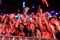 Attendees react as David Guetta takes the Kinetic Field stage during the first night of the Ele ...