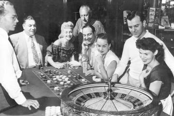 People are shown at one of the gaming tables at the Flamingo Casino in Las Vegas, Nev., on May ...