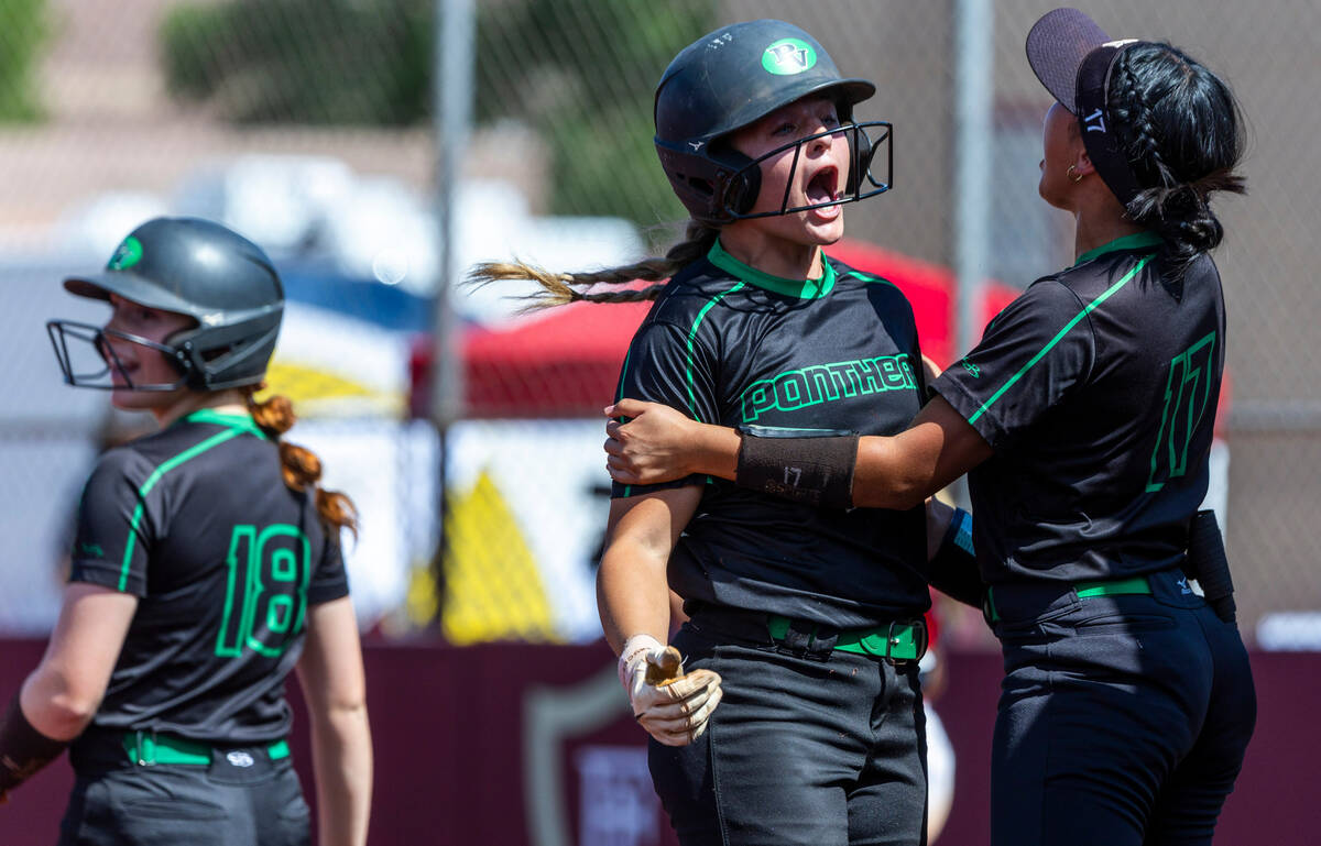 Palo Verde runner Taylor Johns (11) celebrates a score with teammate Makayla Enriquez (17) agai ...