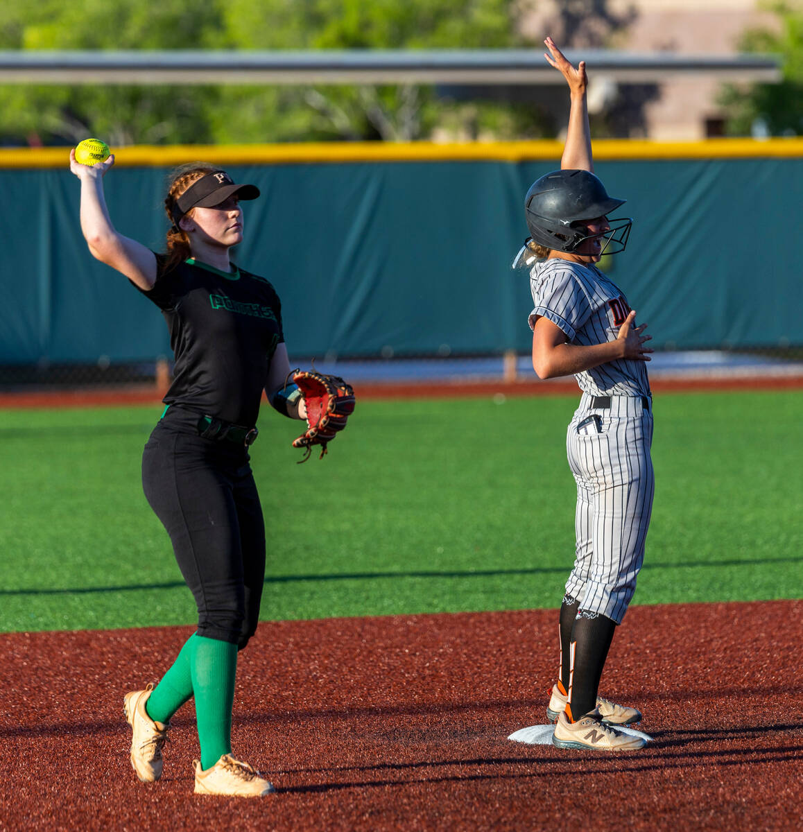 Douglas runner Ava Delaney (5) celebrates her double as Palo Verde infielder Mya Bartlett (15) ...