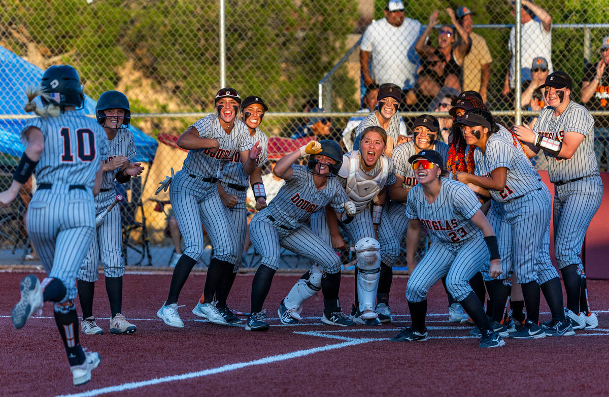 Douglas players ready to welcome teammate Cam McLelland (10) at home plate after a home run aga ...