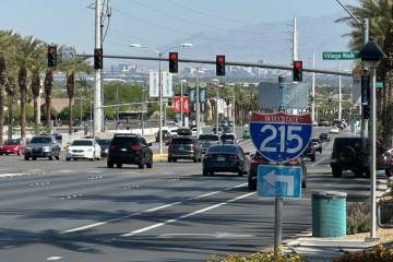 Vehicles pass through the intersection of Green Valley Parkway and Village Walk Drive on Sunday ...