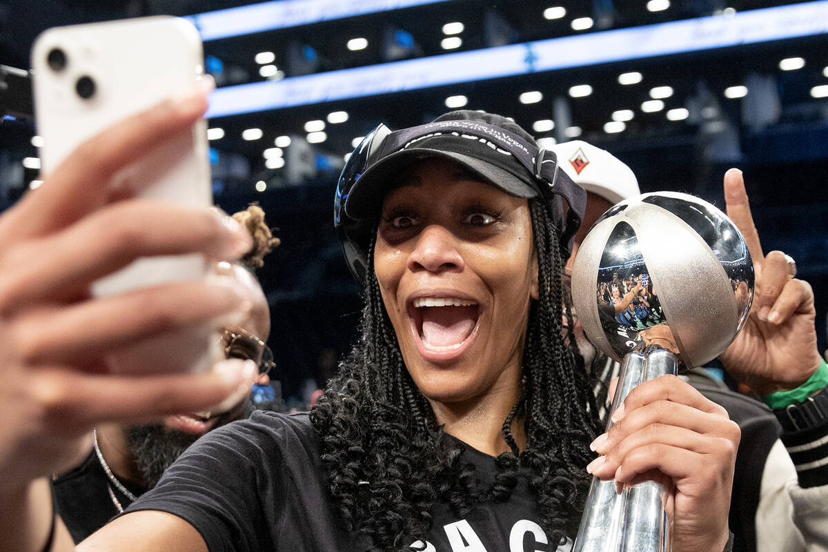 Las Vegas Aces forward A'ja Wilson poses for a selfie with her Most Valuable Player trophy afte ...
