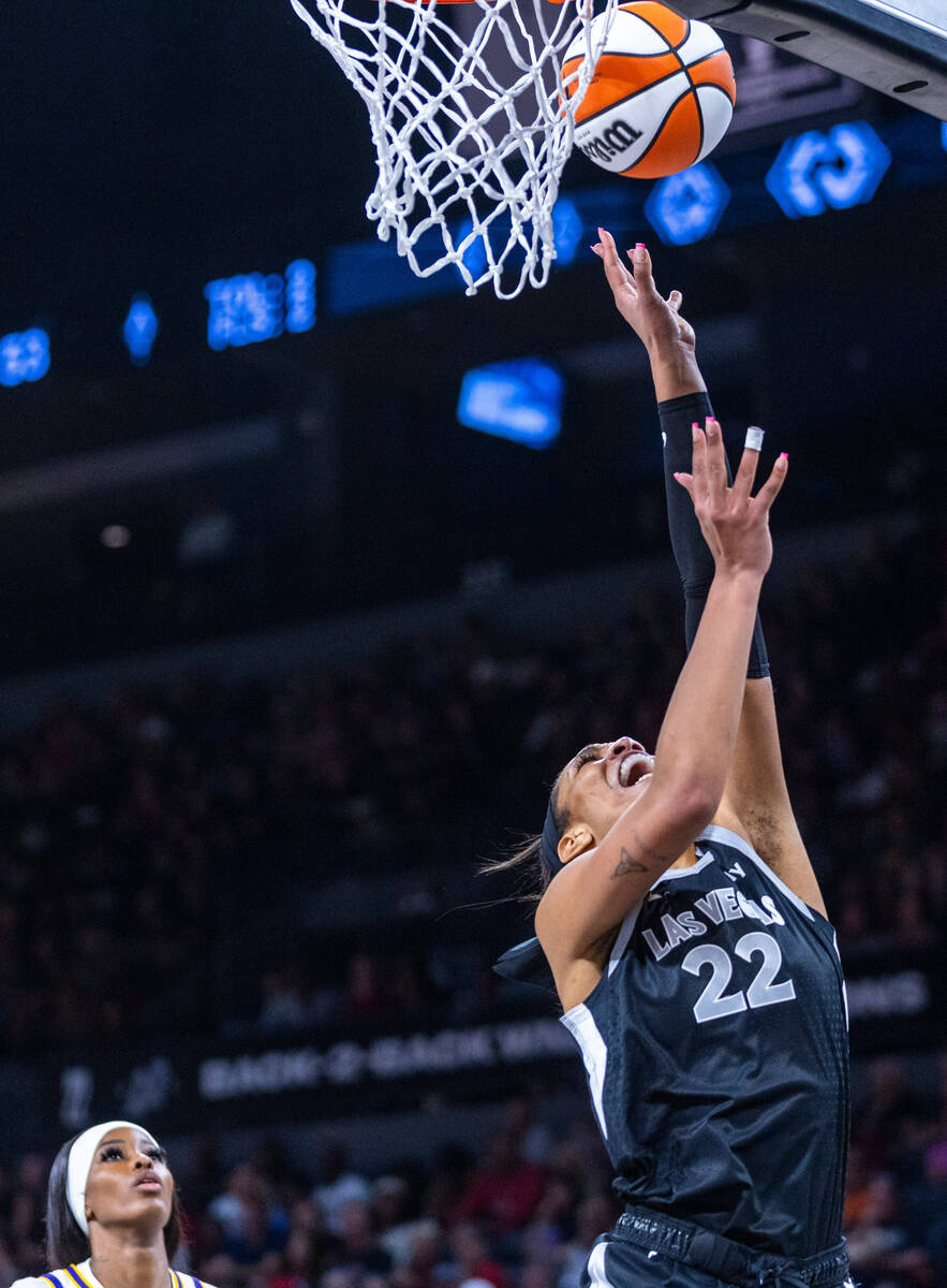 Aces center A'ja Wilson (22) goes underneath the basket for a layup against the Los Angeles Spa ...
