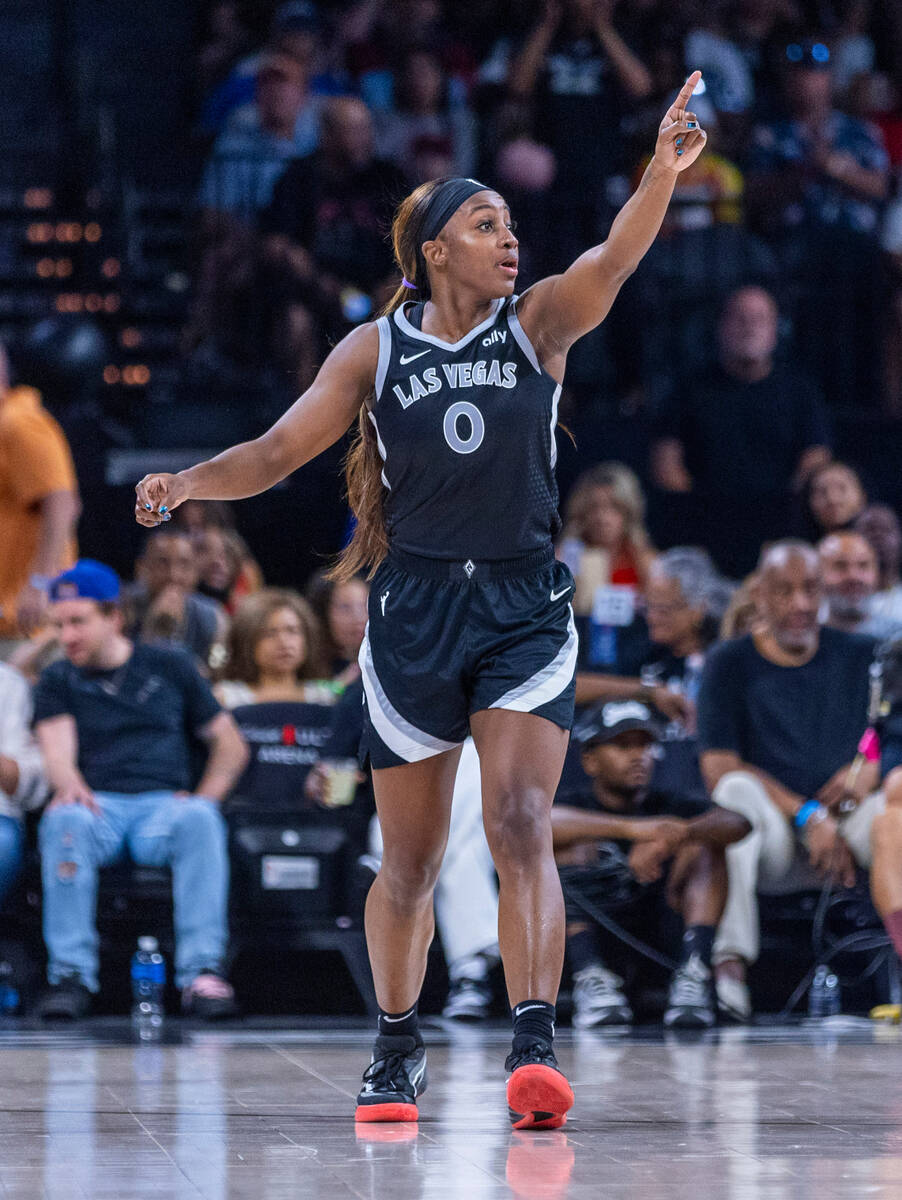 Aces guard Jackie Young (0) signals another three-point basket over the Los Angeles Sparks duri ...