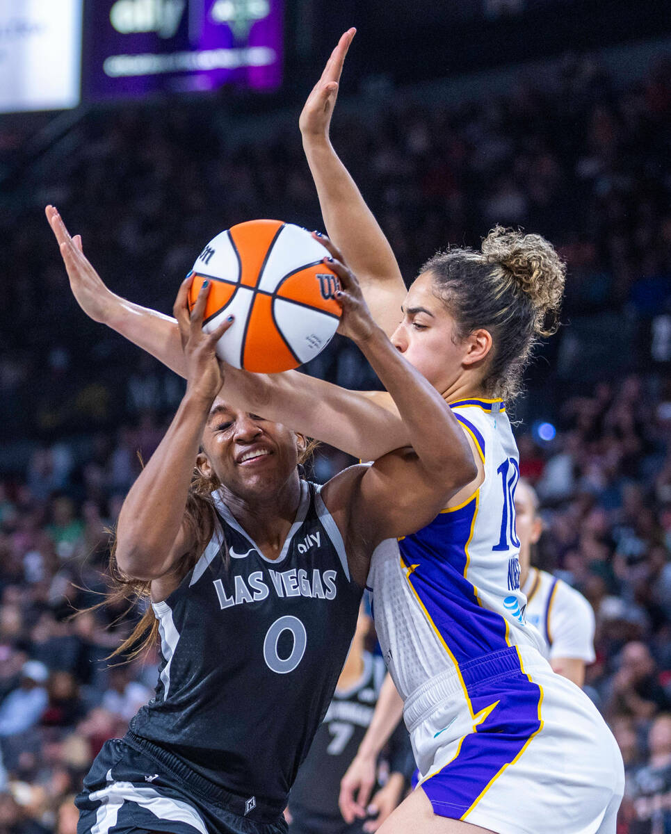 Aces guard Jackie Young (0) battles inside on a drive against the Los Angeles Sparks guard Kia ...