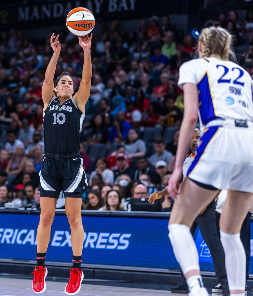 Aces guard Kelsey Plum (10) post up for a three-point basket as Los Angeles Sparks forward Came ...