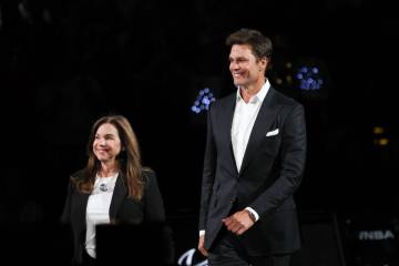 Retired NFL quarterback Tom Brady, who owns a stake in the Las Vegas Aces, walks on stage to re ...