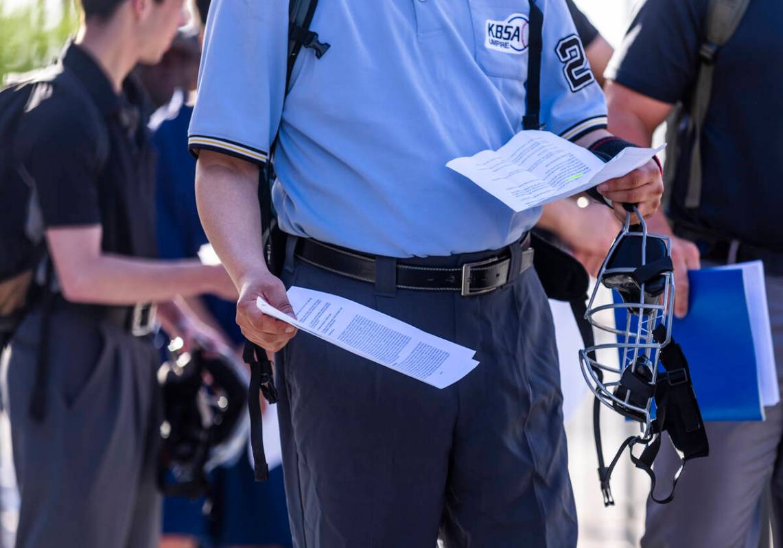 Participants have their paperwork ready as they line up to enter the Las Vegas Ballpark for a M ...