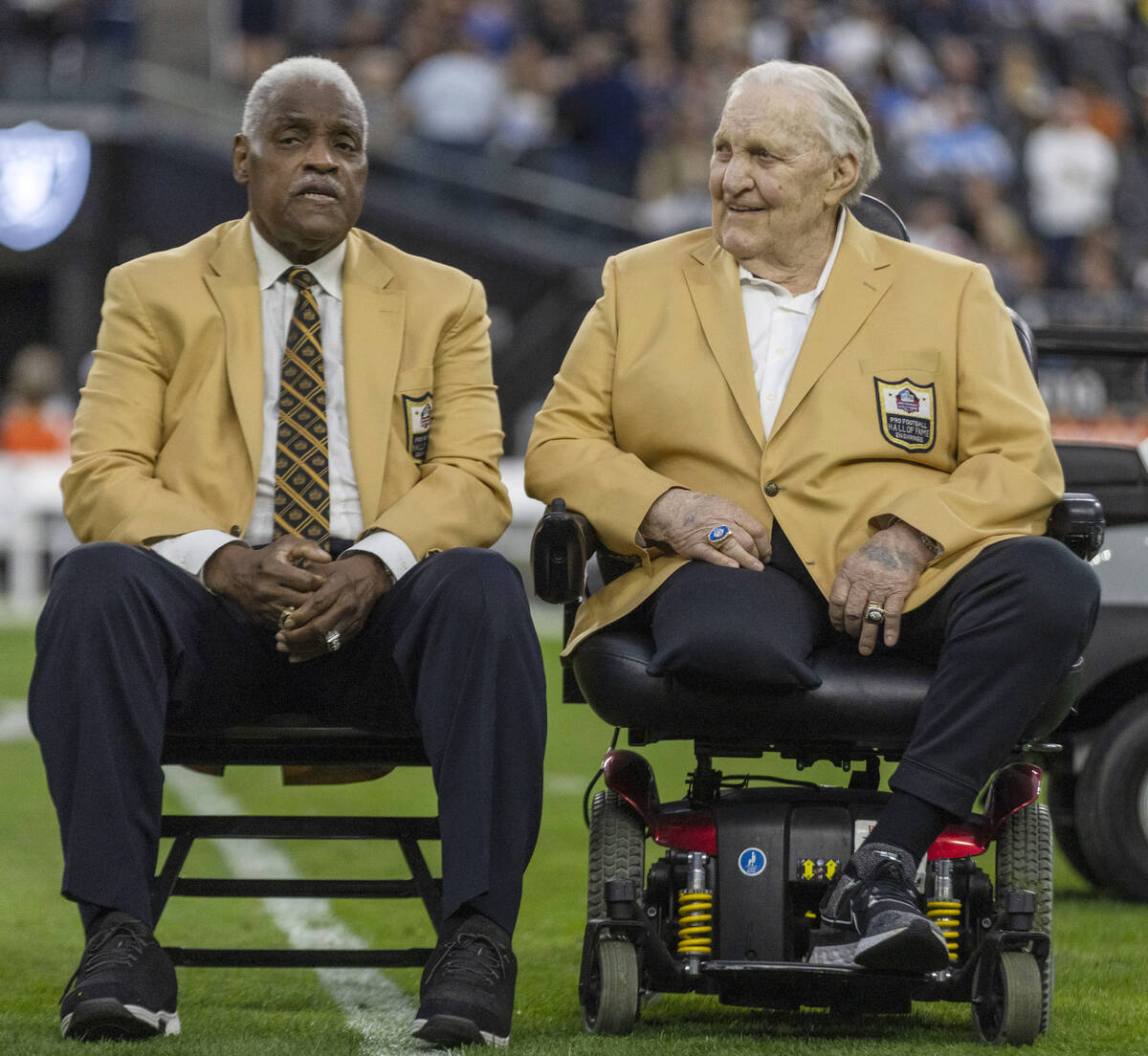 Raiders Hall of Famers Art Shell, left, and Jim Otto arrive on the field for a halftime ceremon ...