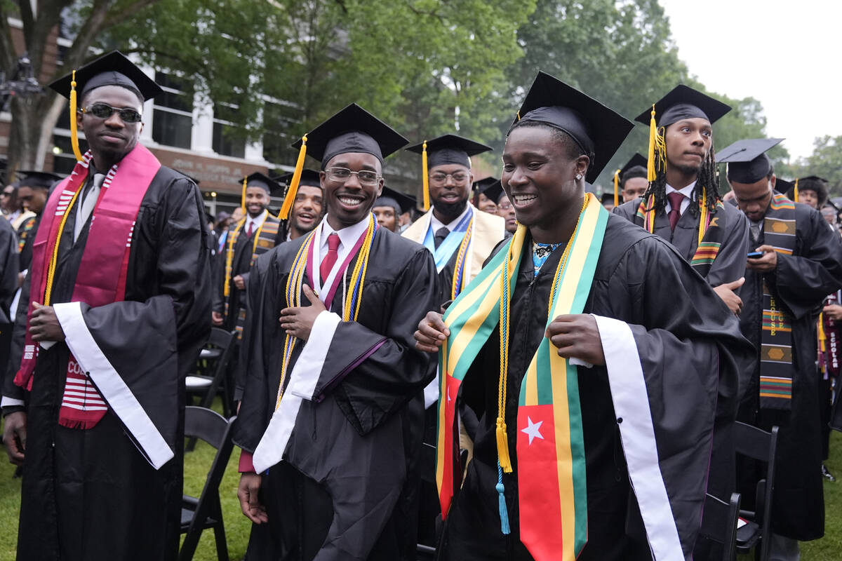 Graduating students arrive at the Morehouse College commencement before President Joe Biden spe ...