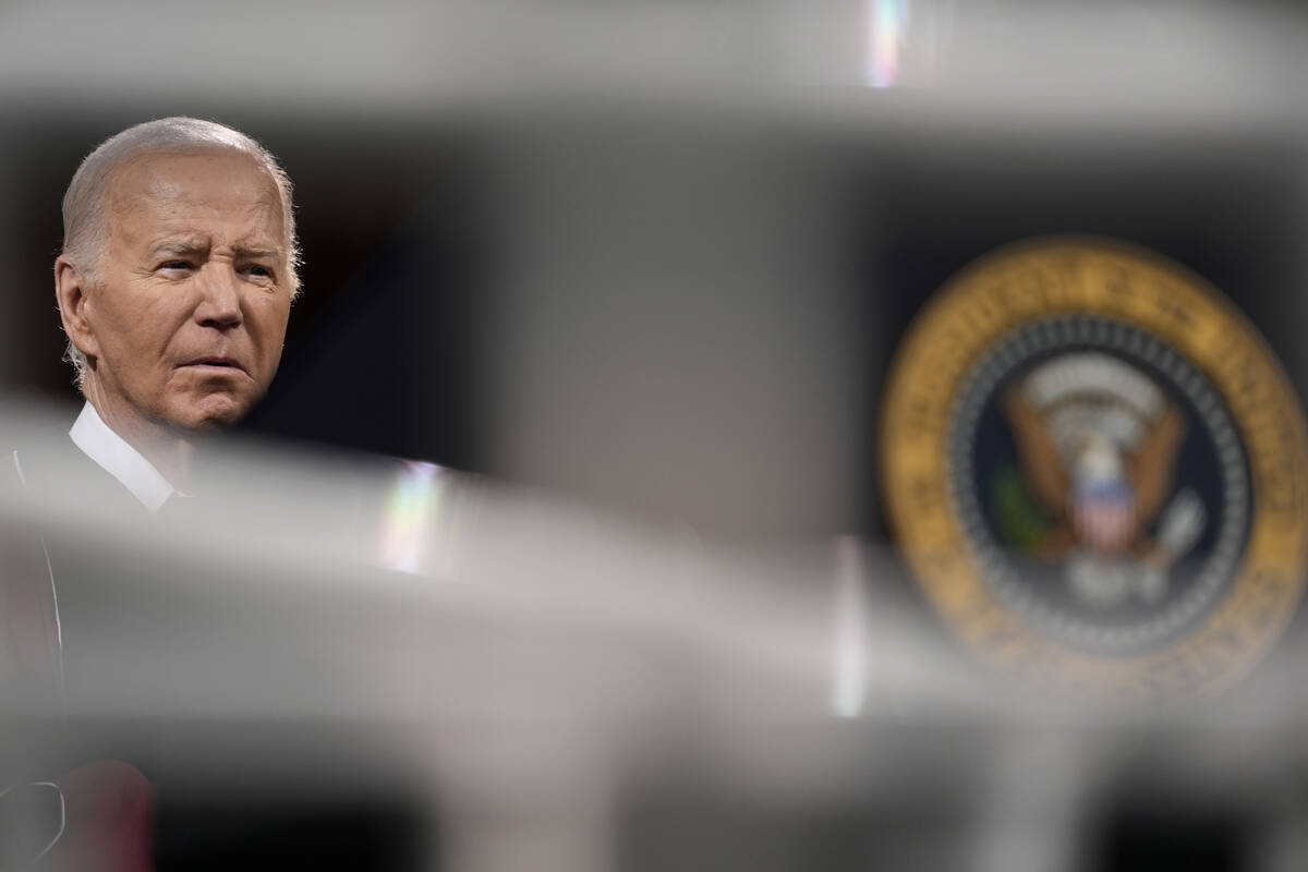 President Joe Biden listens before speaking to graduating students at the Morehouse College com ...