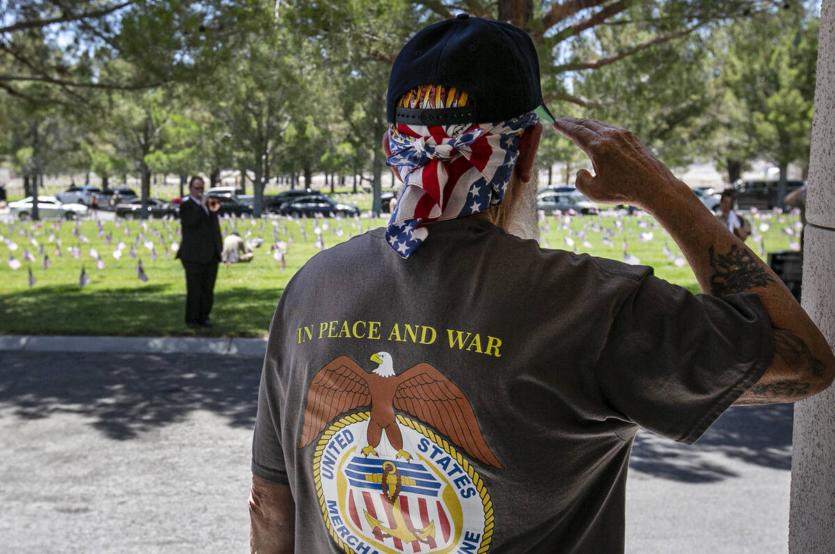 Retired U.S. merchant Marine veteran Kenneth DeLancey salutes as he attends the 2024 Memorial D ...