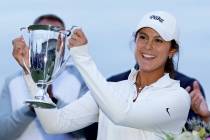 Yana Wilson holds up a trophy after winning the American Junior Golf Association tournament hel ...