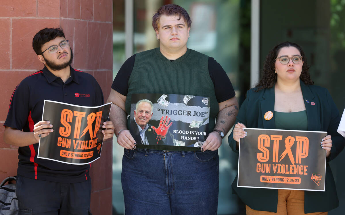 Students, including from left, Rayan Muneer, Mack Gledhill and Zena Hajji, hold signs during a ...