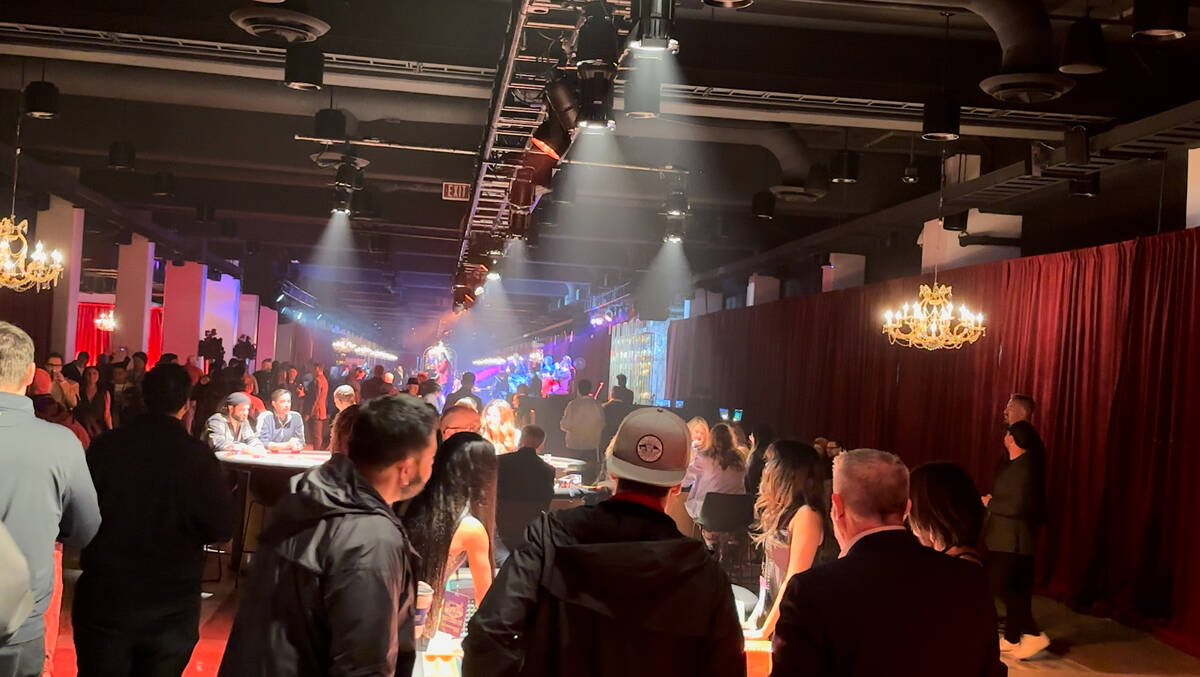 Guests mingle at the Las Vegas Super Bowl Host Committee media party at the Formula One Las Veg ...
