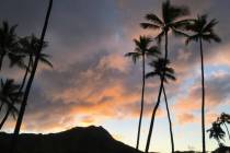 The sun rises behind the Diamond Head State Monument in Honolulu in 2018. (AP Photo/Eric Risberg)