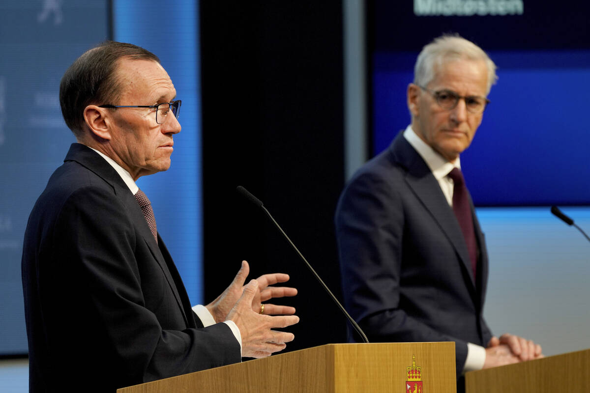 Norway's Prime Minister Jonas Gahr Store, right, and Foreign Minister Espen Barth Eide speak du ...