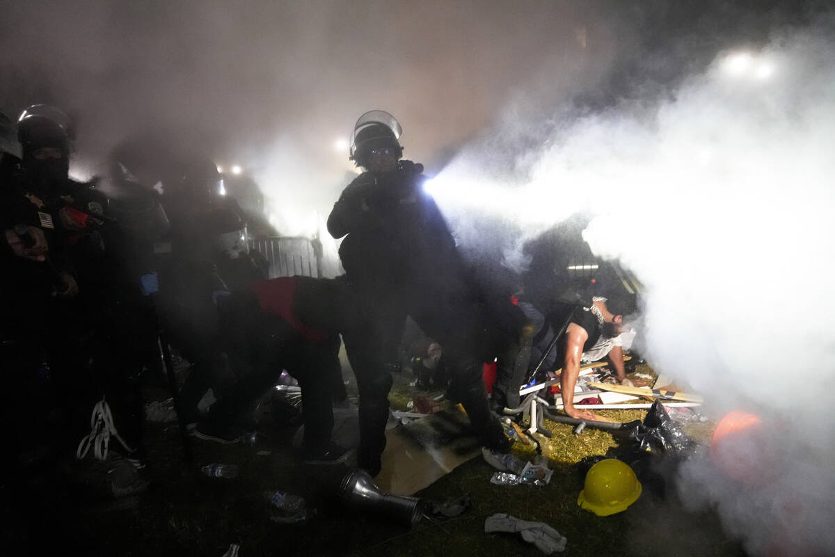 FILE - Police enter an encampment set up by pro-Palestinian demonstrators on the University of ...