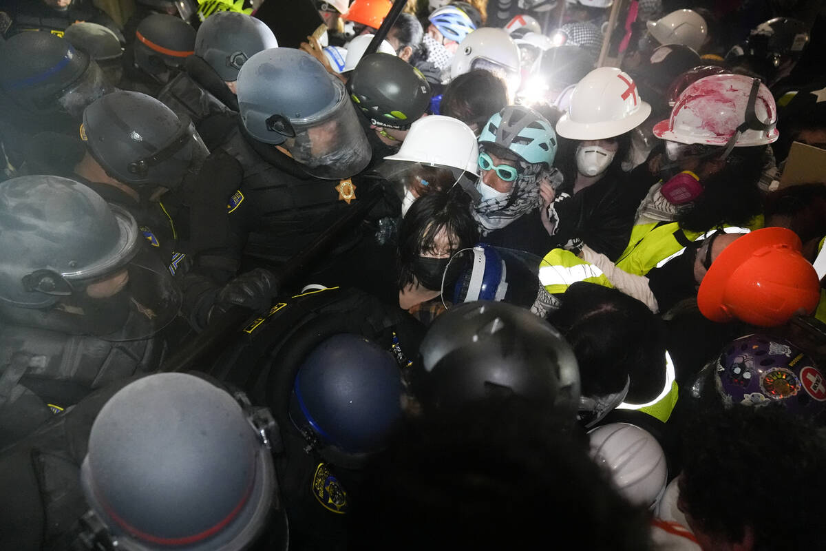 FILE - Police face off with pro-Palestinian demonstrators inside an encampment on the UCLA camp ...