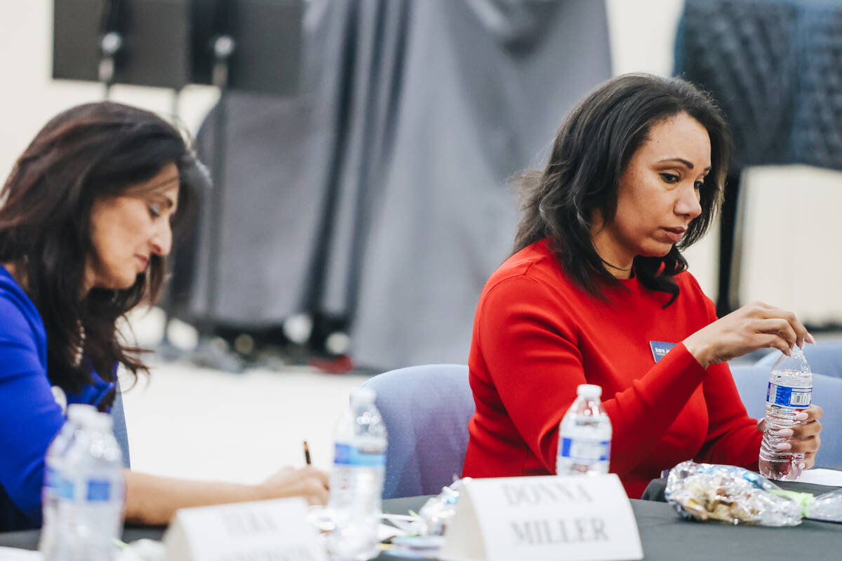 Mayoral candidate Kara Jenkins listens to another mayoral candidate speak during a forum for th ...