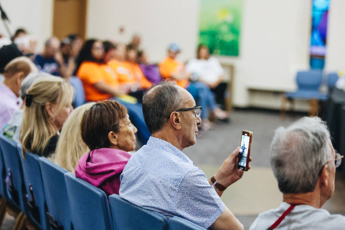 A member of the crowd films mayoral candidate William Walls during a forum for the candidates r ...