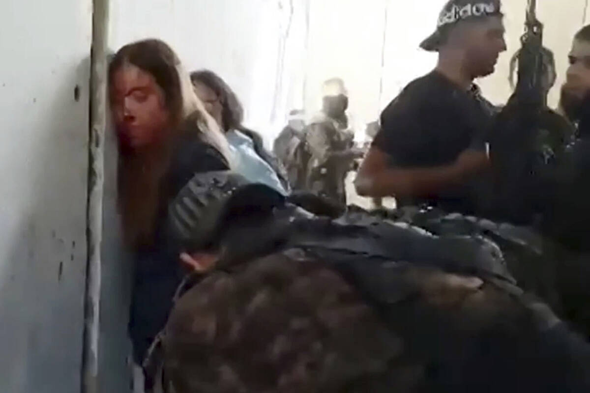 In this image taken from video provided by the Hostage Families Forum, Israeli female soldiers ...