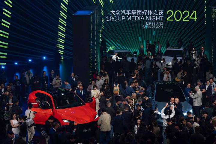 Attendees at an auto show in Beijing, Wednesday, April 24, 2024. (AP Photo/Ng Han Guan)